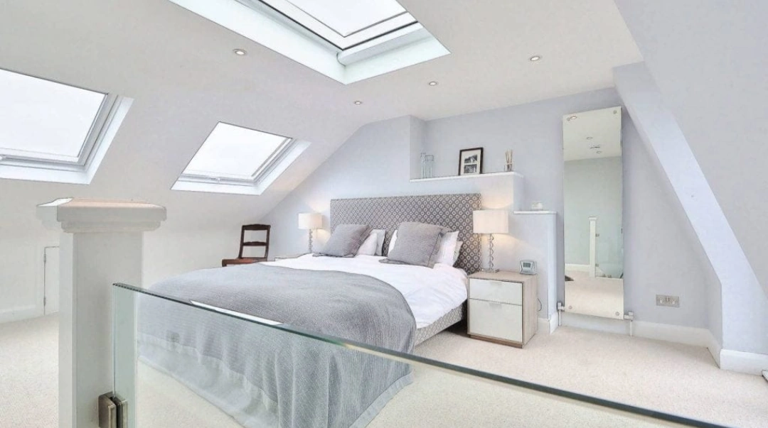 Warm completed top-floor bedroom filled with natural light